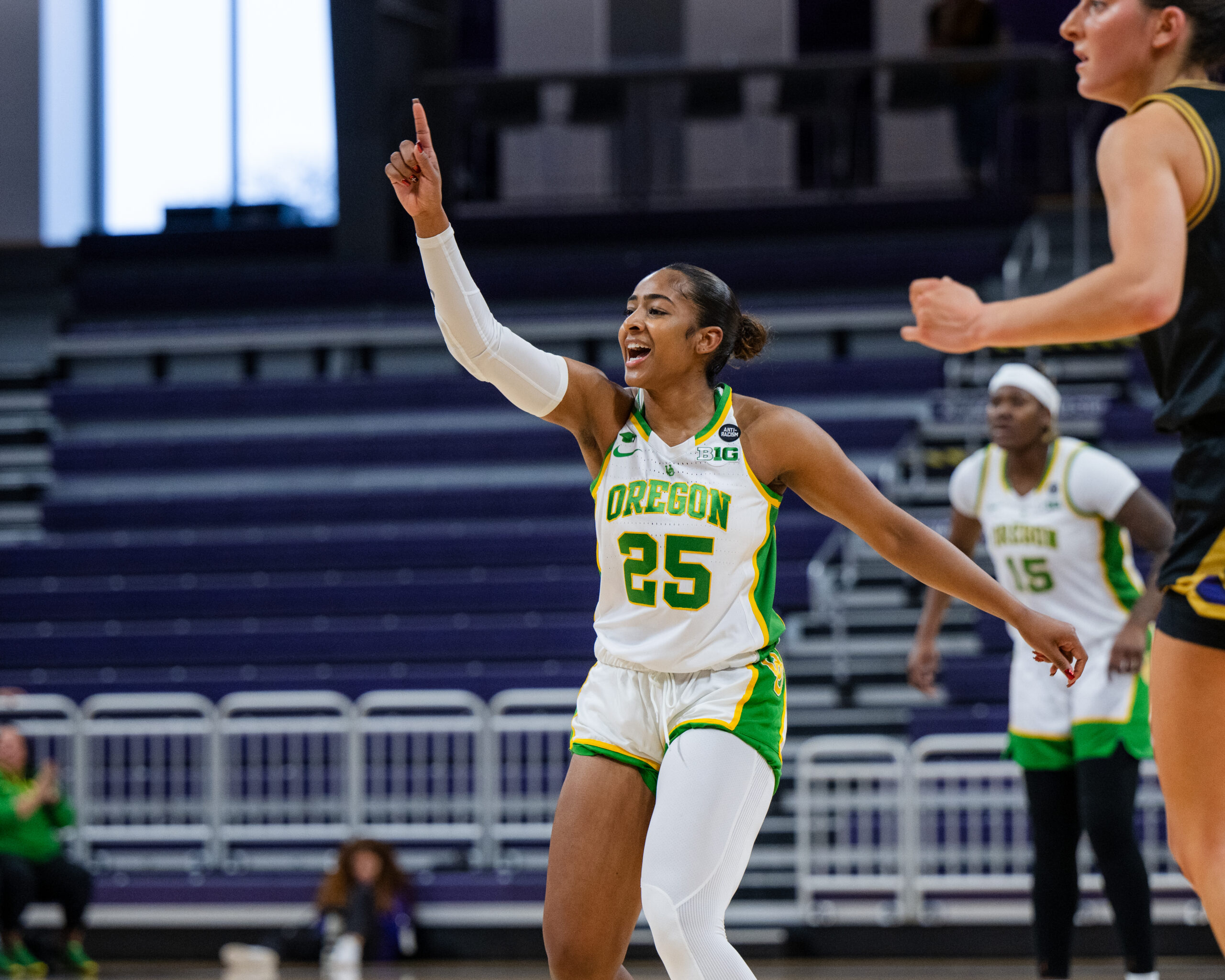 Deja Kelly points her finger in the air on the court.