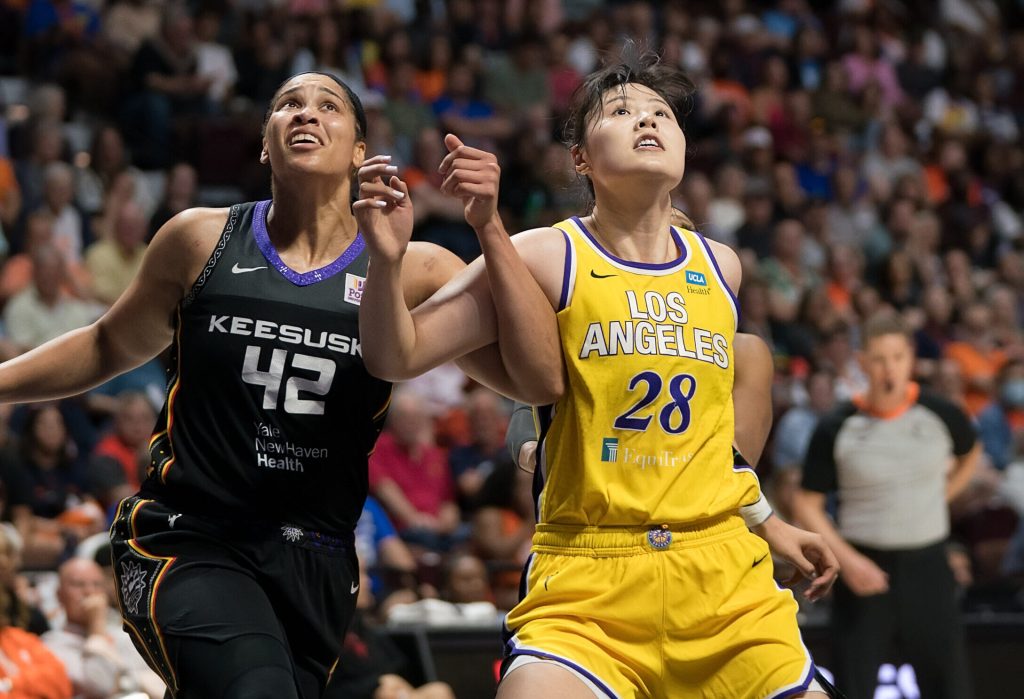 Connecticut Sun forward Brionna Jones' and Los Angeles Sparks center Li Yueru's arms get tangled up as they fight for rebounding position.