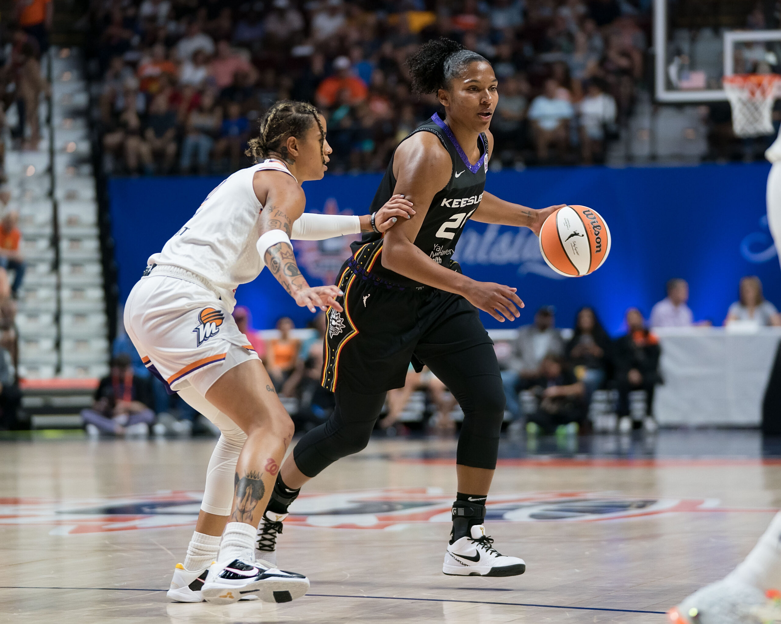 Connecticut Sun forward Alyssa Thomas (25) dribbles the ball while Phoenix Mercury guard Natasha Cloud (0) defends her