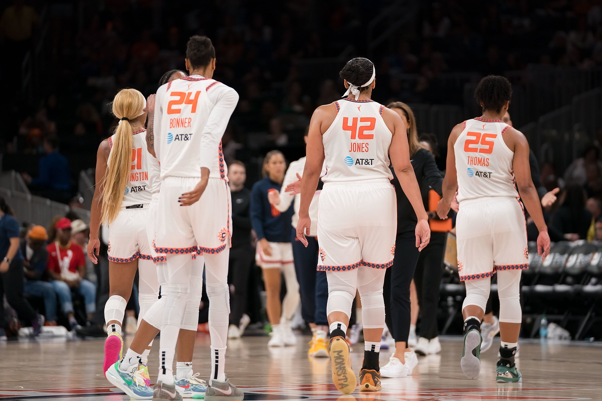 Connecticut Sun players walk on court during game.