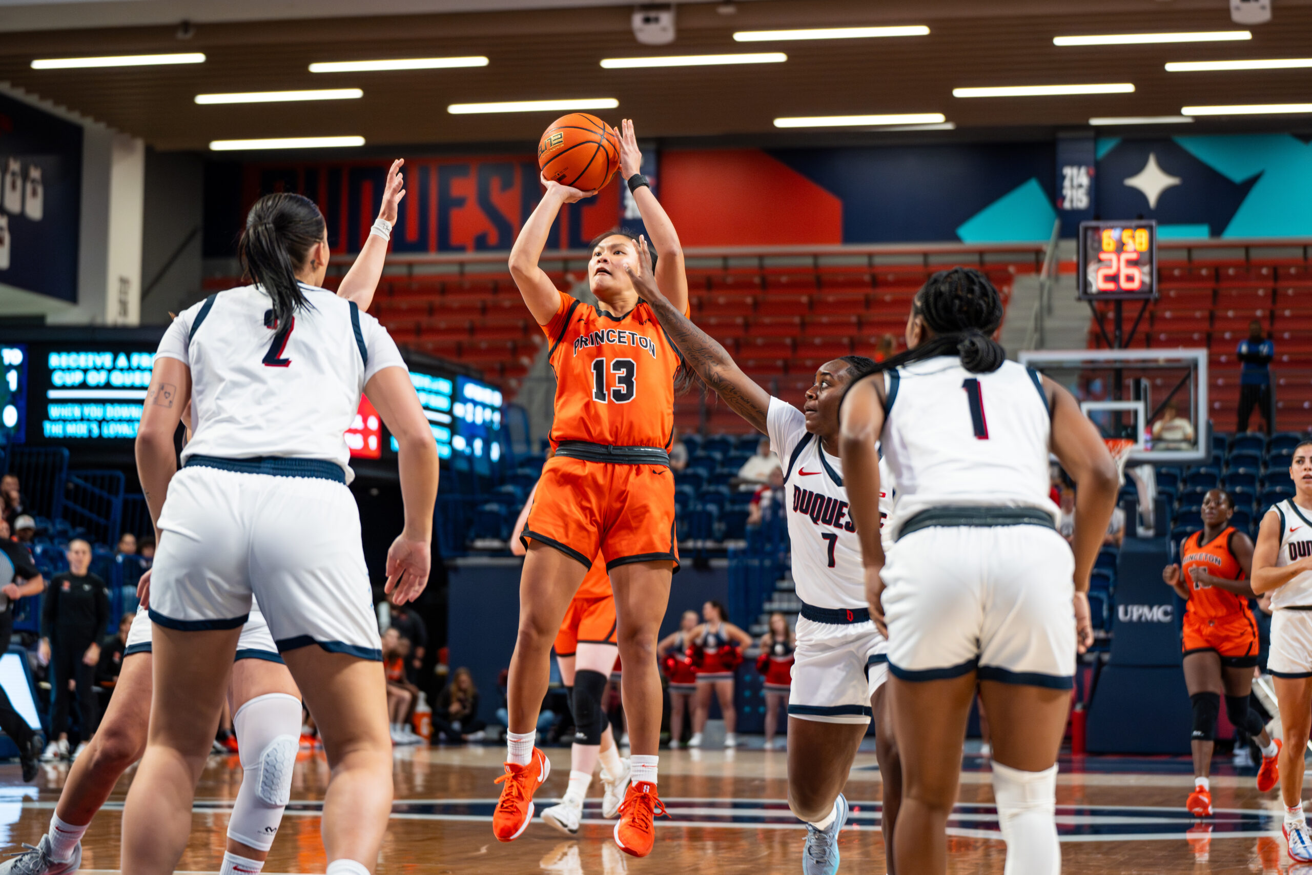 Princeton guard Ashley Chea shoots a right-handed jump shot. Several Duquesne defenders are nearby but aren't close enough to fully contest it.