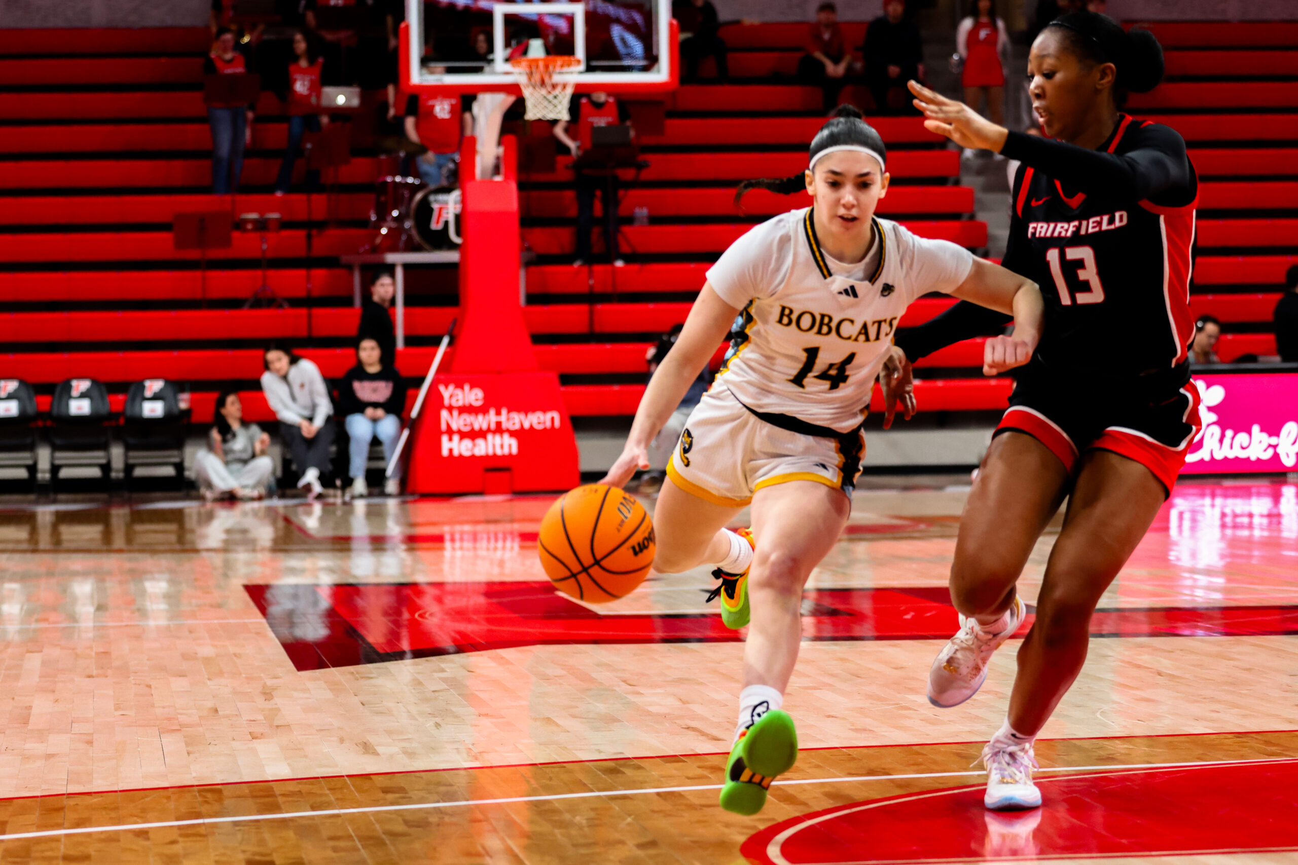 Quinnipiac guard Gal Raviv dribbles the basketball with her right hand as a defender stays with her on her left hip.