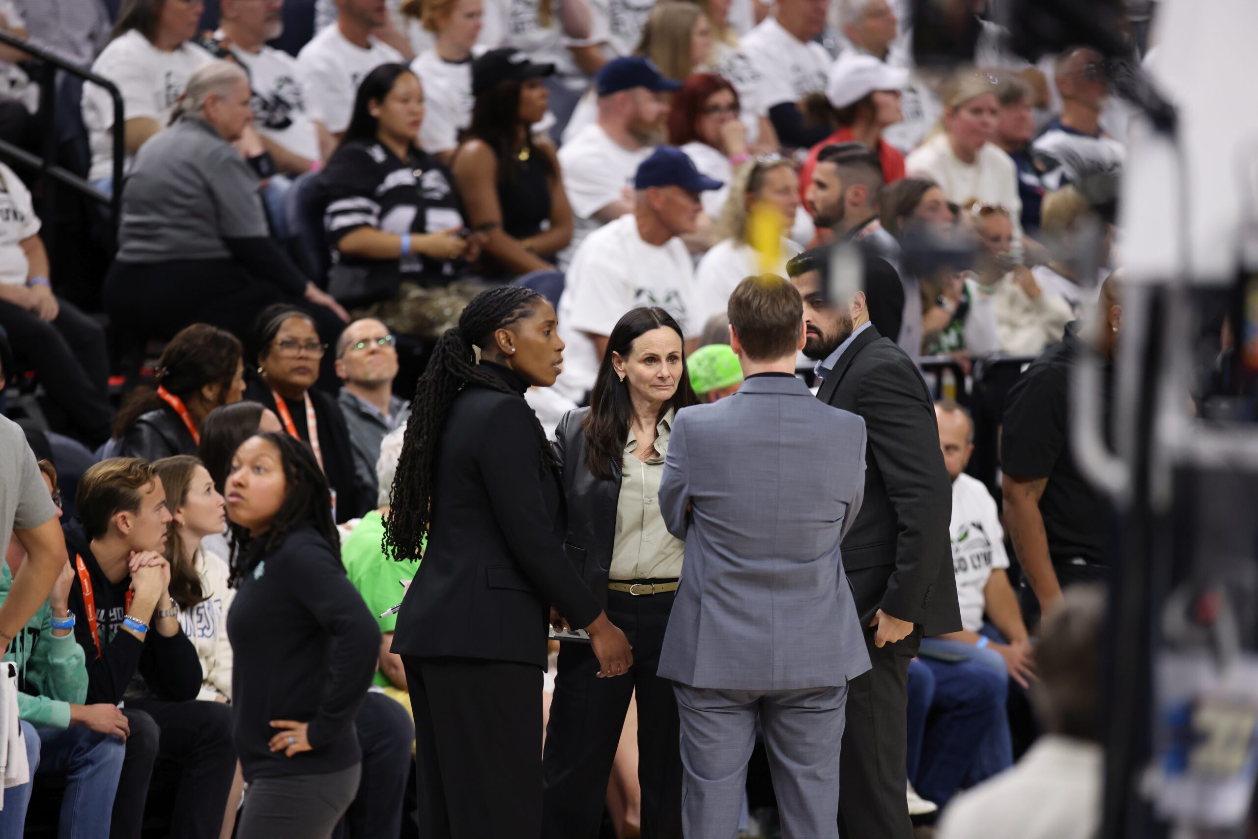 New York Liberty head coach Sandy Brondello huddles with assistant coach Olaf Lange, assistant coach Zack O'Brien and now former assistant coach Roneeka Hodges during a timeout.