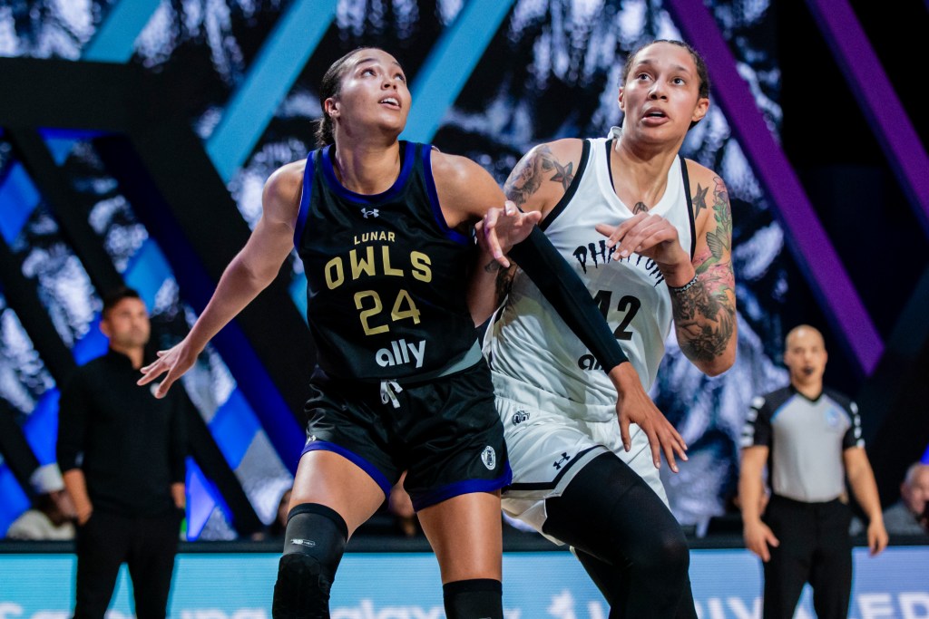 Two players battle during a basketball game on the court