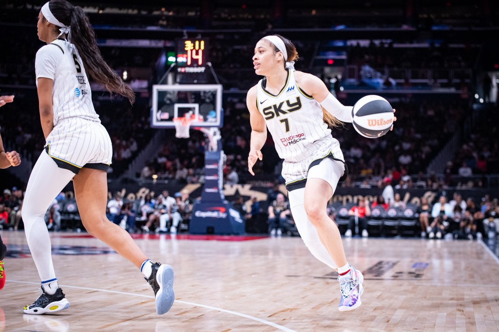 Chennedy Carter dribbles with her left hand outside the 3-point line