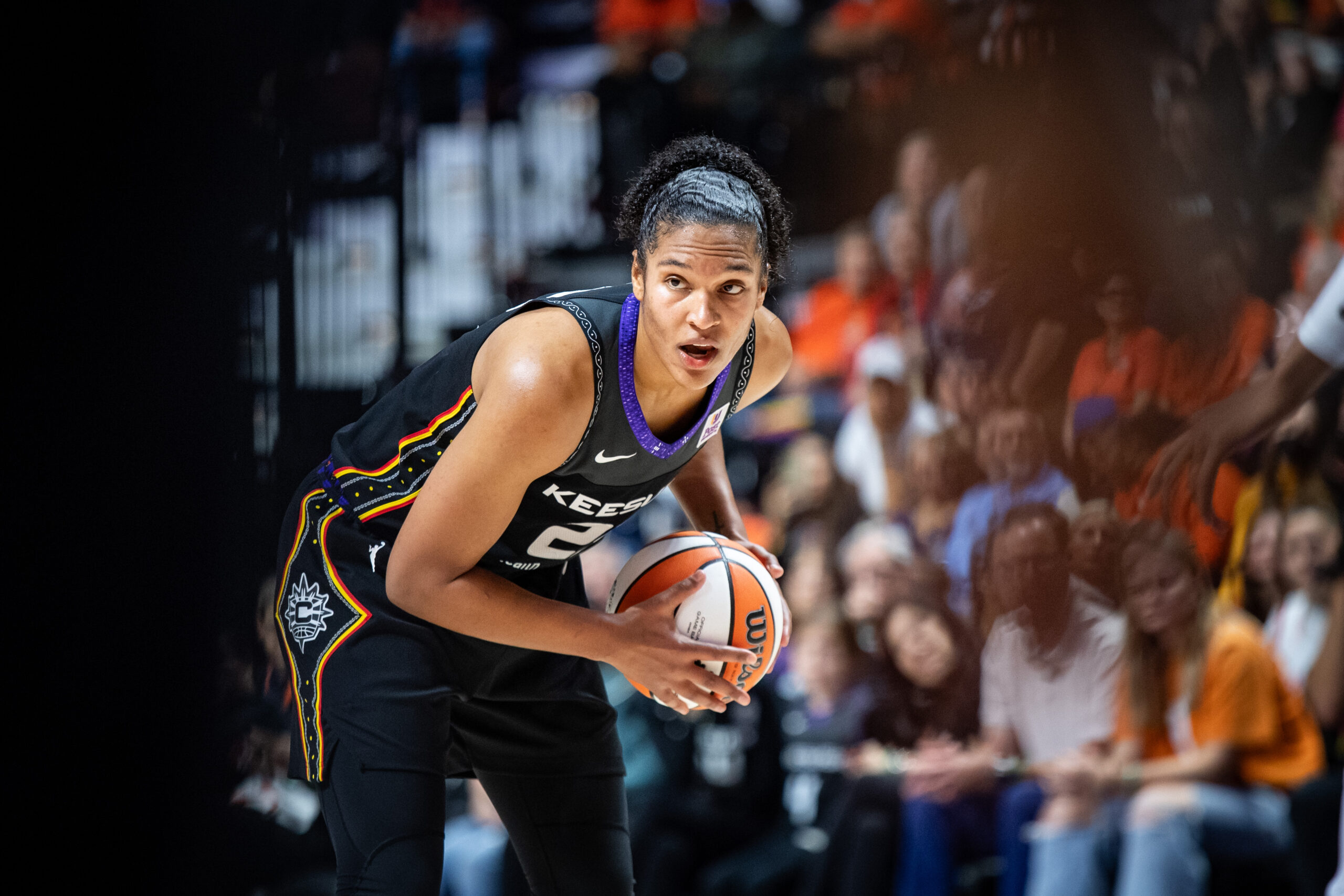 Alyssa Thomas holds the basketball in a game.