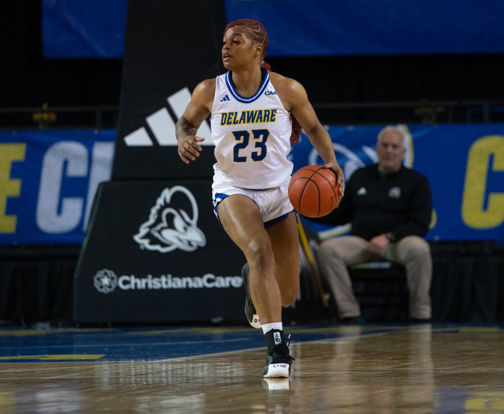 Delaware's Chloe Wilson dribbles the ball up the floor during a game in the 2024-25 season. (Photo credit: Mikey Reeves, University of Delaware Athletics)