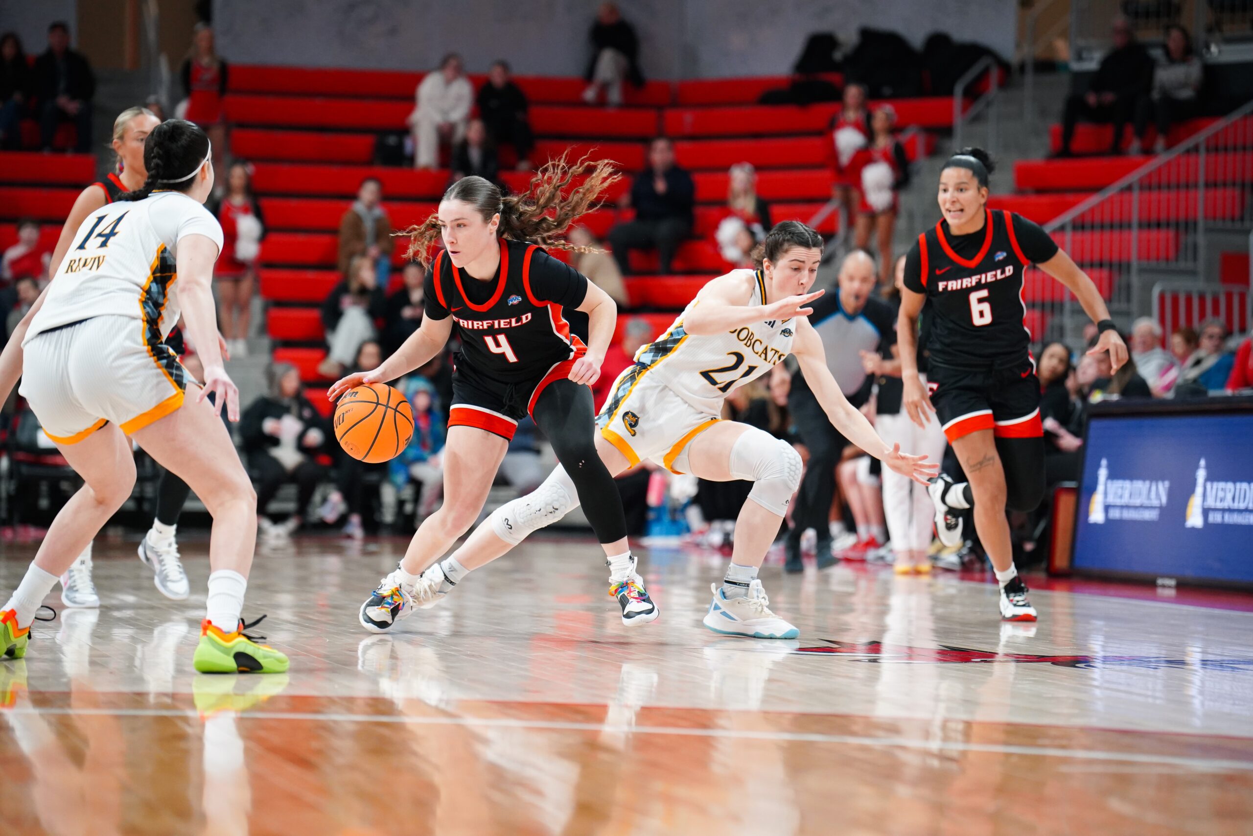 Fairfield sophomore guard Kaety L'Amoreaux dribbles the ball upcourt while looking to her right.