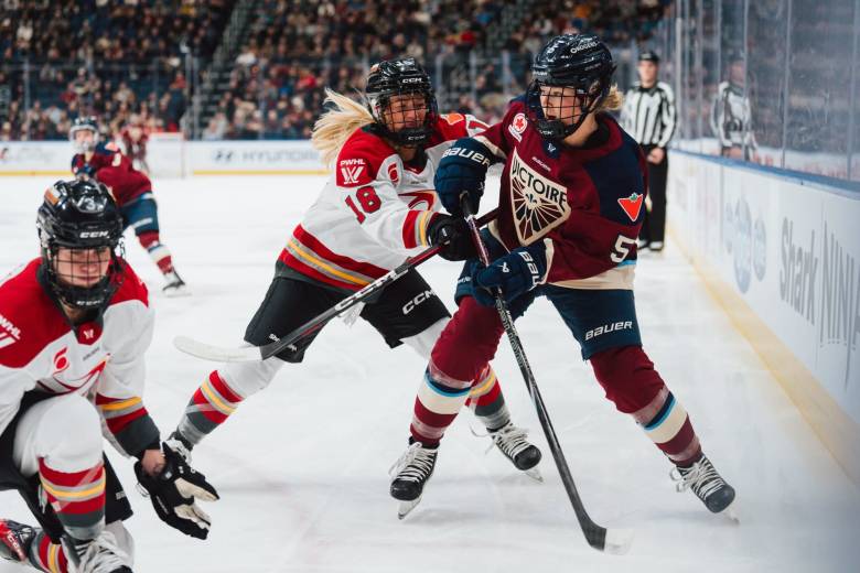 Ottawa Charge and Montreal Victoire battle along boards | Photo Cred: Professional Women's Hockey League