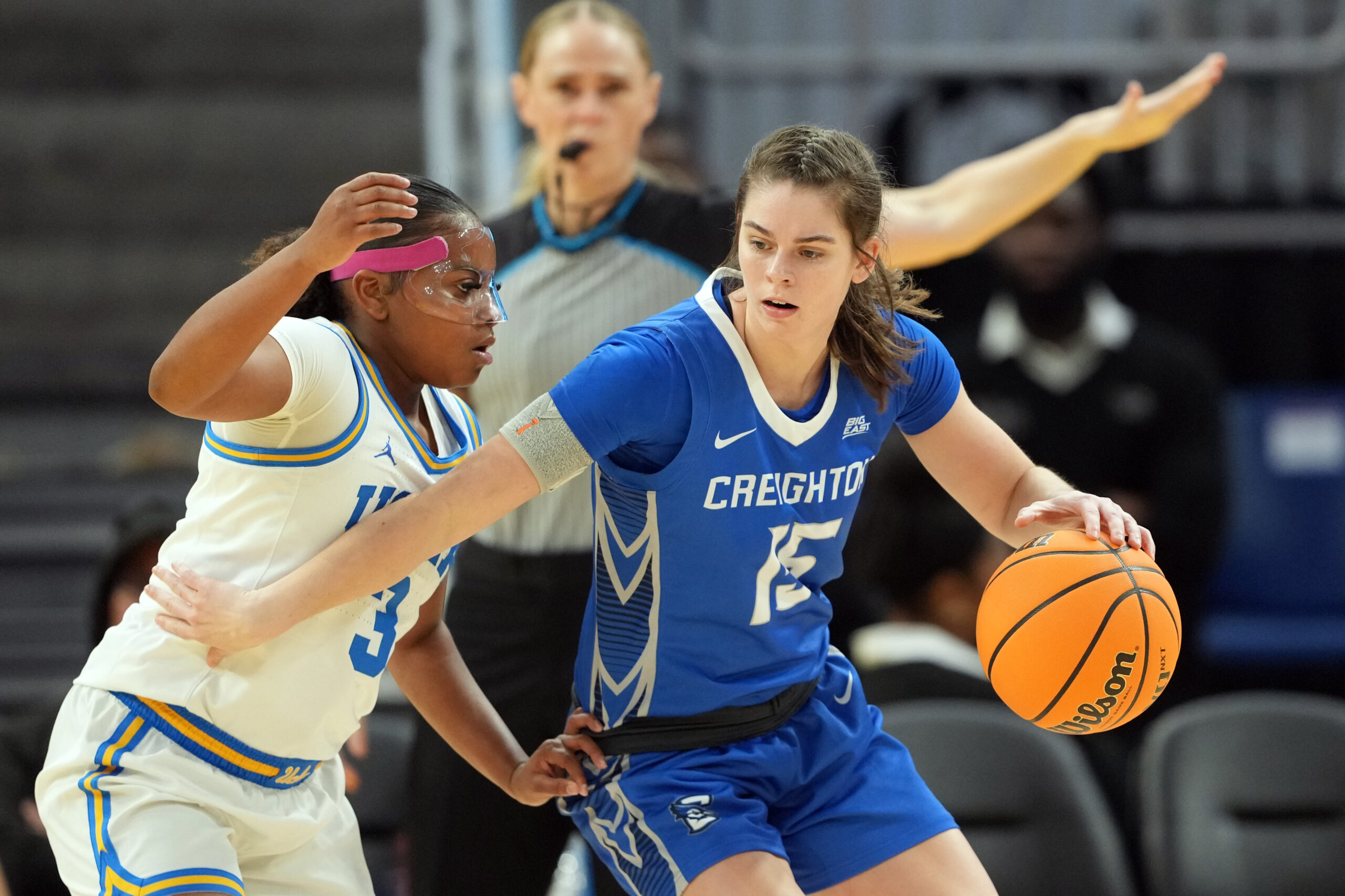Creighton guard Lauren Jensen dribbles against a UCLA defender