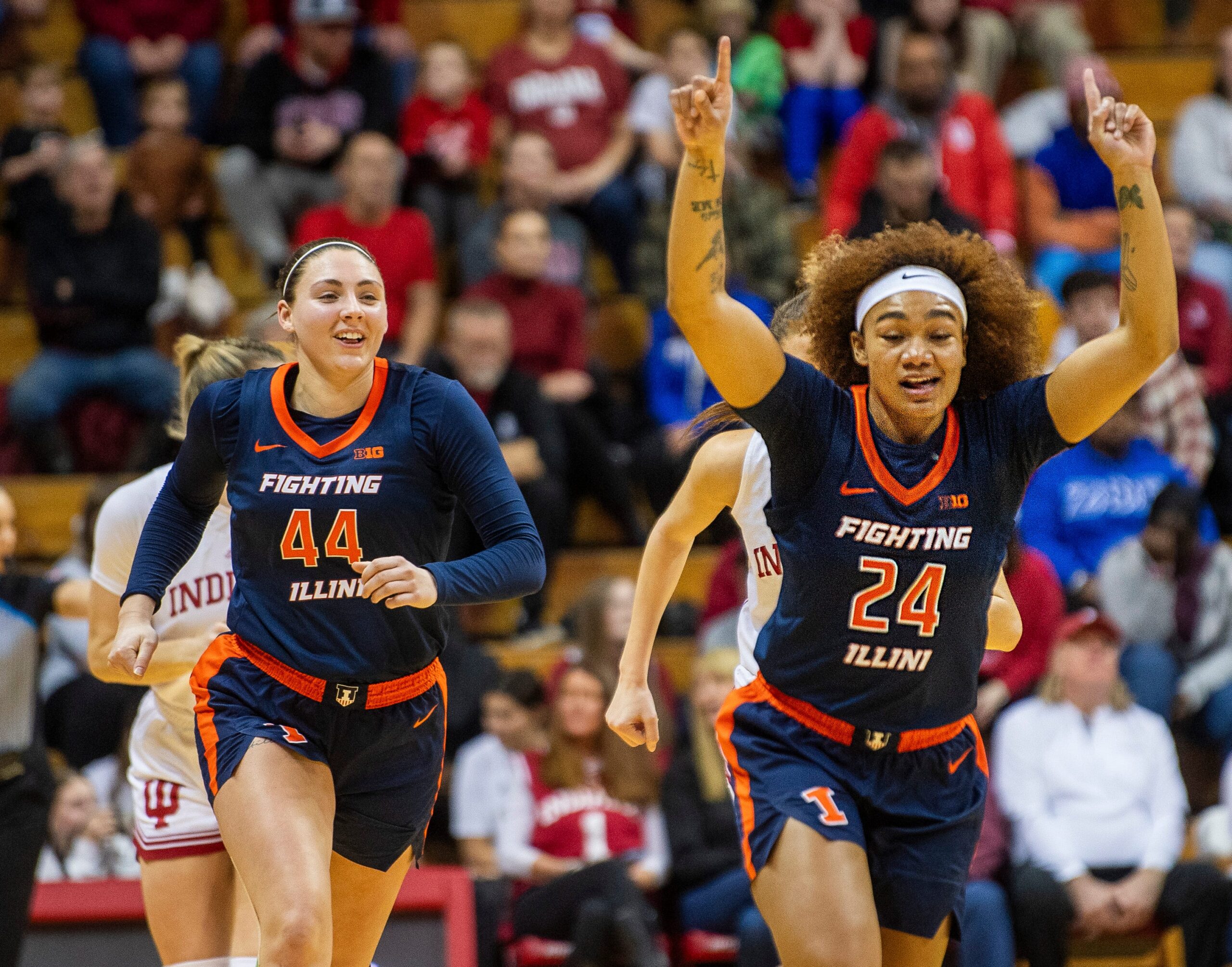 Illinois' Adalia McKenzie and Kendall Bostic run back up the floor after McKenzie's made basket. McKenzie points both index fingers toward the sky and Bostic smiles.