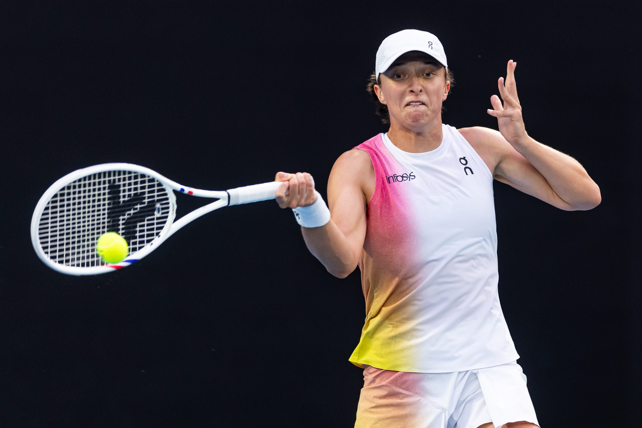 Iga Swiatek hits a forehand in her fourth round match at the 2025 Australian Open