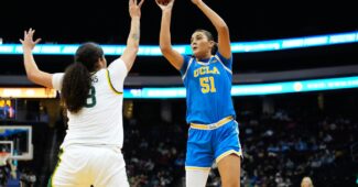 Lauren Betts shoots over a defender.