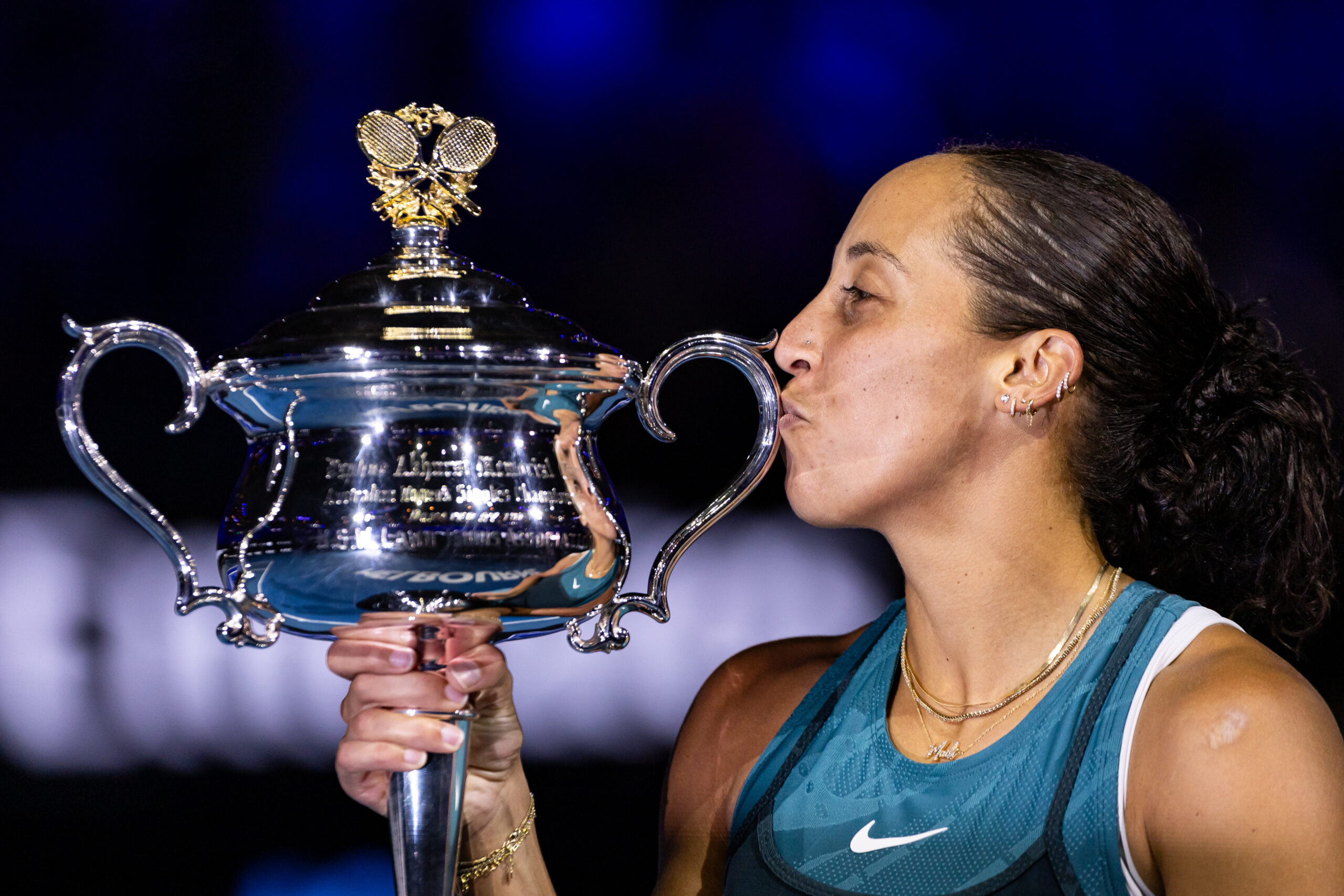 Madison Keys kisses the trophy after capturing the 2025 Australian Open.