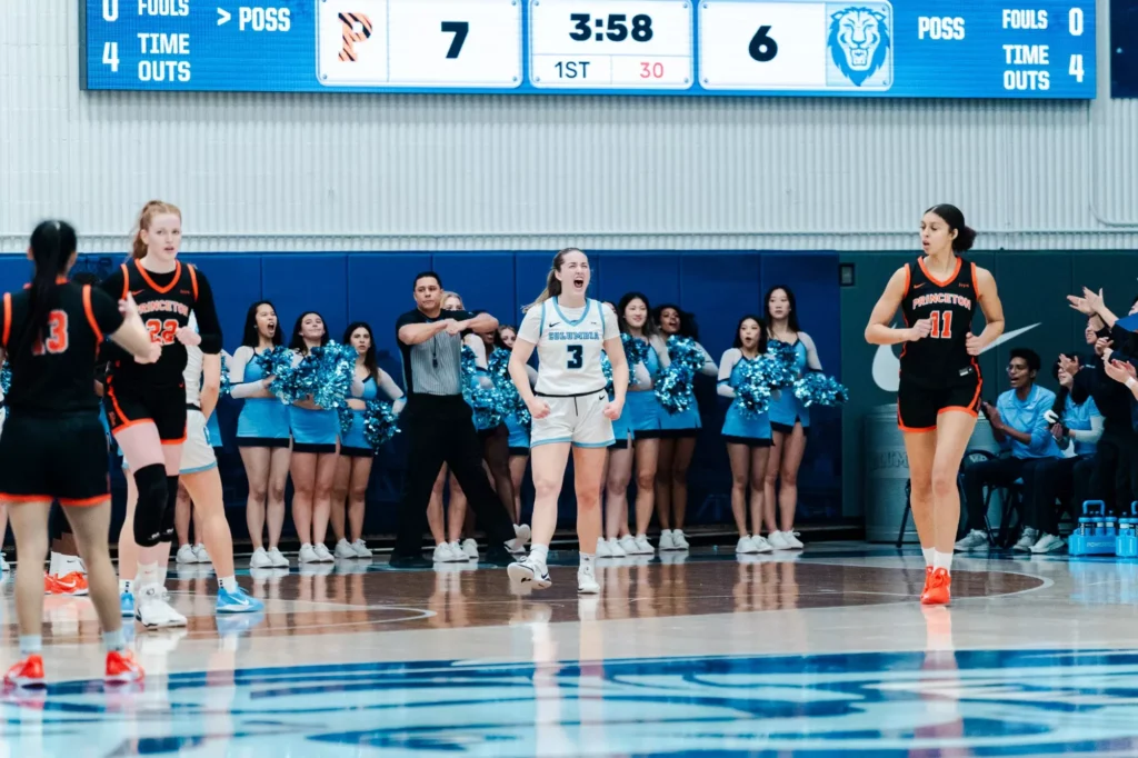 Columbia guard Cecelia Collins flexes downward and yells after a Princeton player was called for traveling.