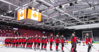 Team Canada standing as the national anthem plays.