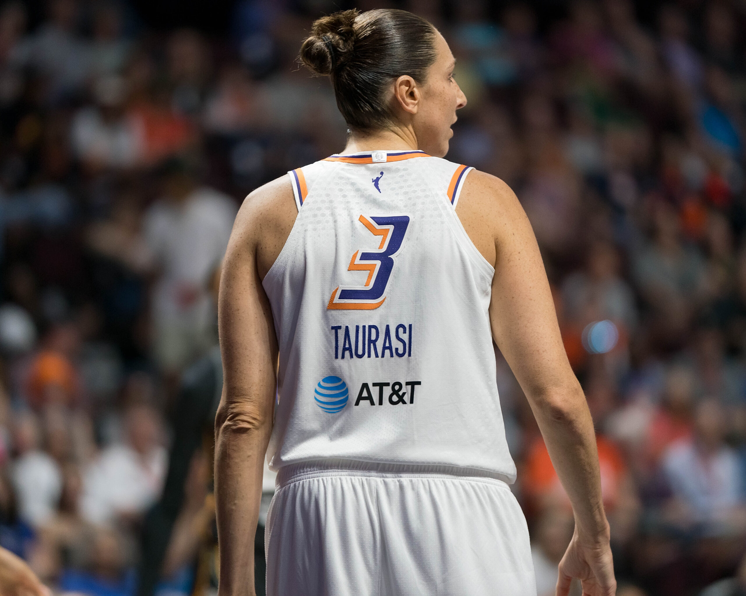 Phoenix Mercury guard Diana Taurasi stands with her head turned to the right
