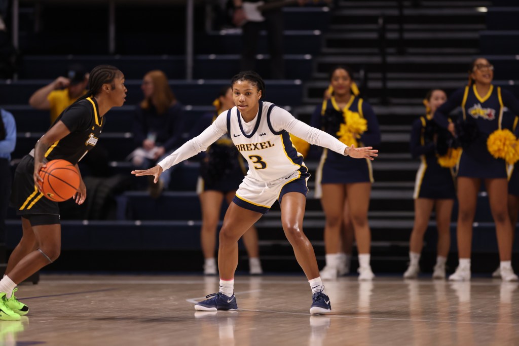 Drexel's Amaris Baker spreads her arms wide and bends her knees to stay in front of a Towson ball-handler.