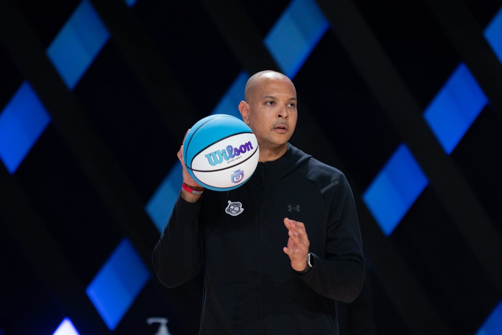 Andrew Wade holds an Unrivaled light blue and purple basketball