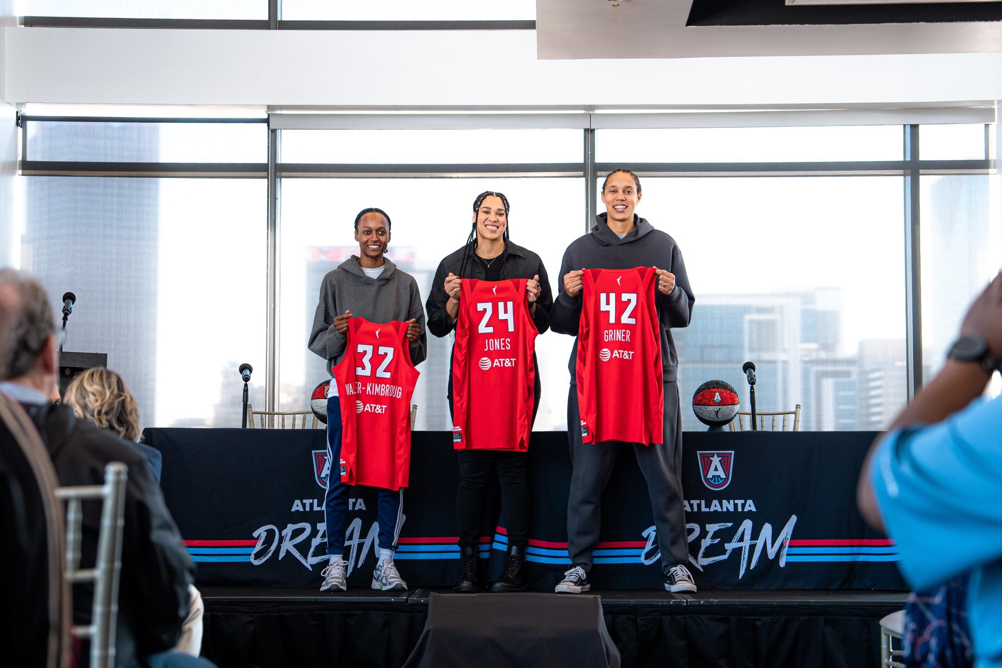 Shatori Walker-Kimbrough, Brionna Jones and Brittney Griner hold up the back of their new Atlanta Dream jerseys during their introductory press conference.