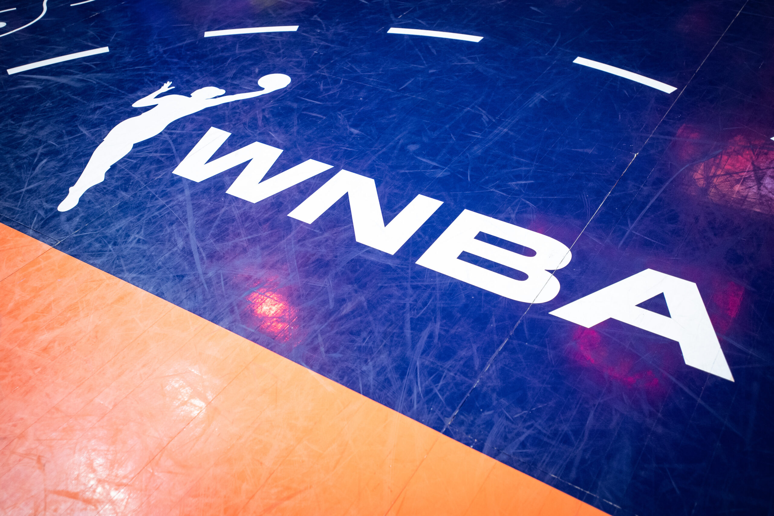 The WNBA logo is seen on the court at Mohegan Sun Arena on Sept. 25, 2024 ahead of a WNBA playoff matchup between the Indiana Fever and the Connecticut Sun.