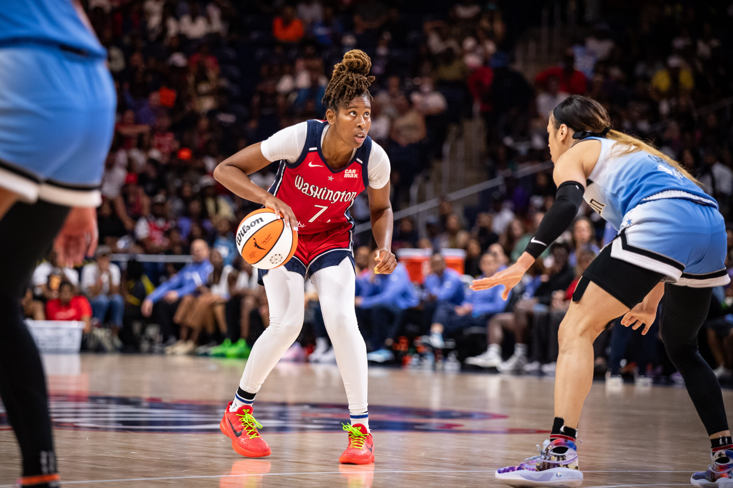 Washington Mystics guard Ariel Atkins palms the ball with her right hand while looking at the rim while Chicago Sky guard Chennedy Carter is in a defensive stance in front of her