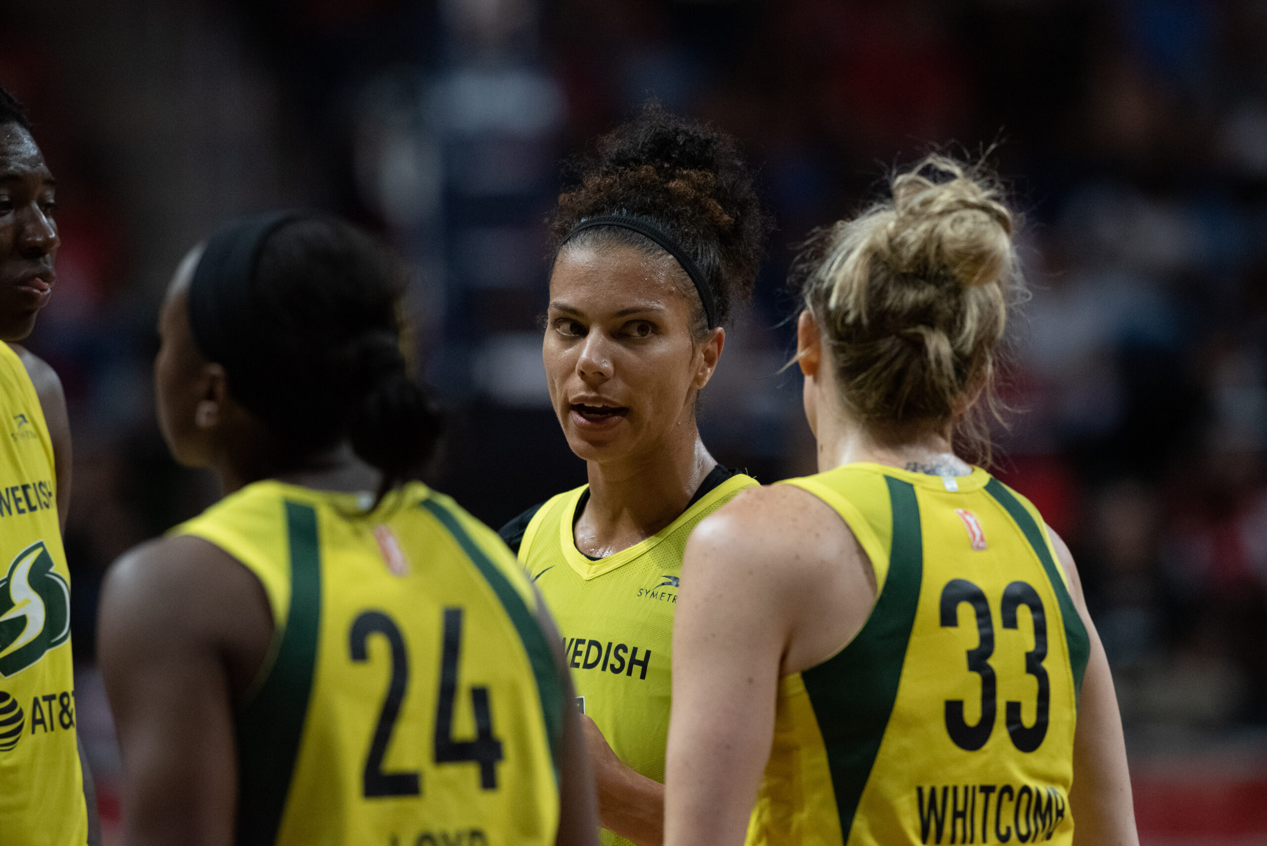 Then-Seattle Storm forward Alysha Clark talks with teammate Sami Whitcomb during a game.