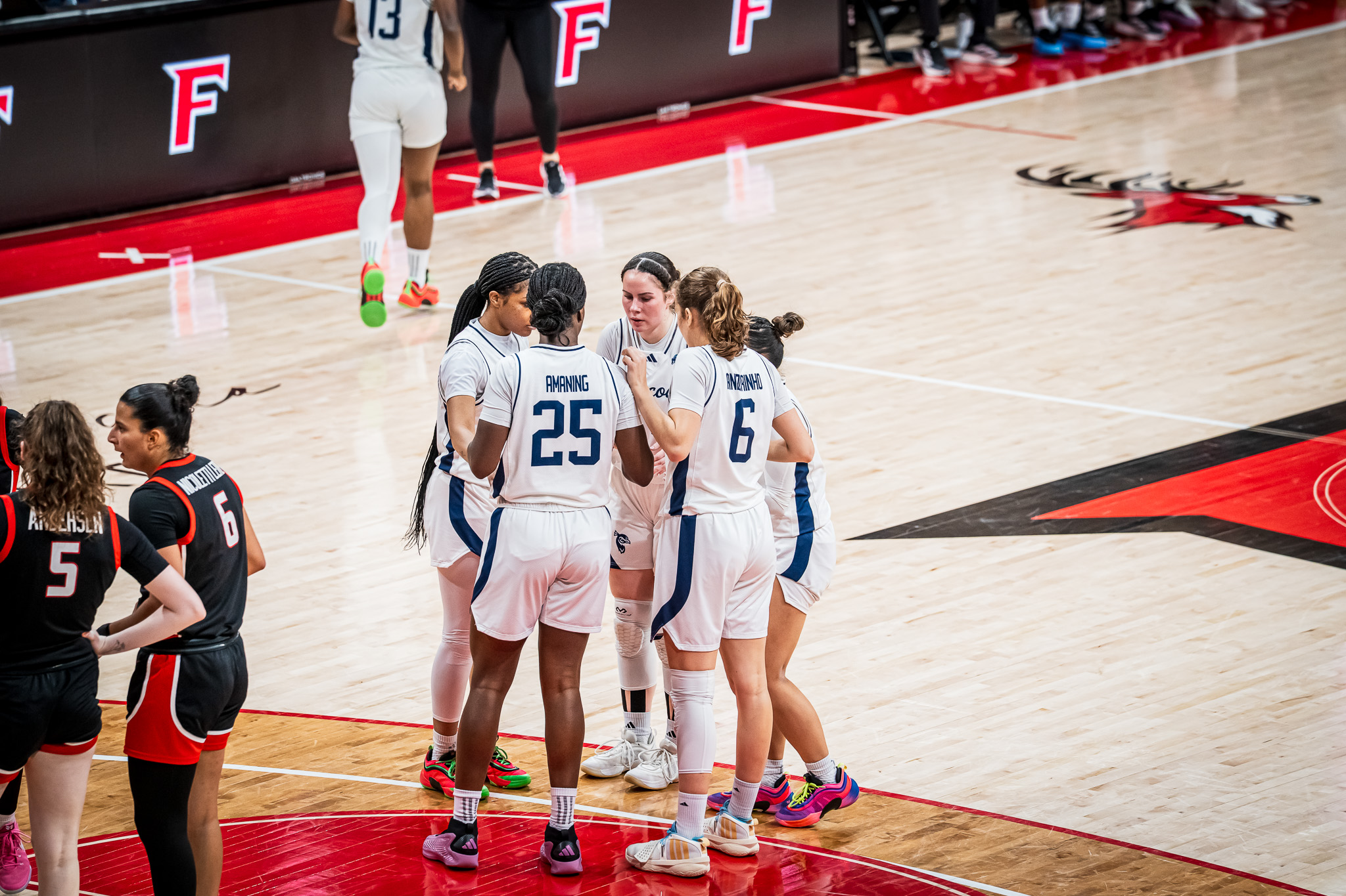 Saint Peter's huddles up together right inside the three-point line at Leo D. Mahoney Arena.