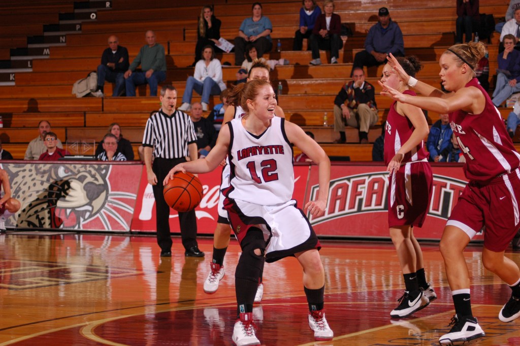 Lafayette forward Emily Garner dribbles the ball with her right hand. She is standing on the free throw line and looking for options as a defender slides her feet to stay with Garner.