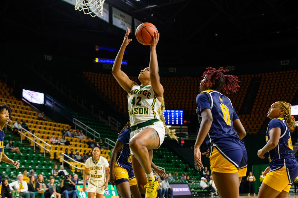 George Mason forward Nalani Kaysia goes up for a left-handed layup with her left knee in the air and no defenders in her path.