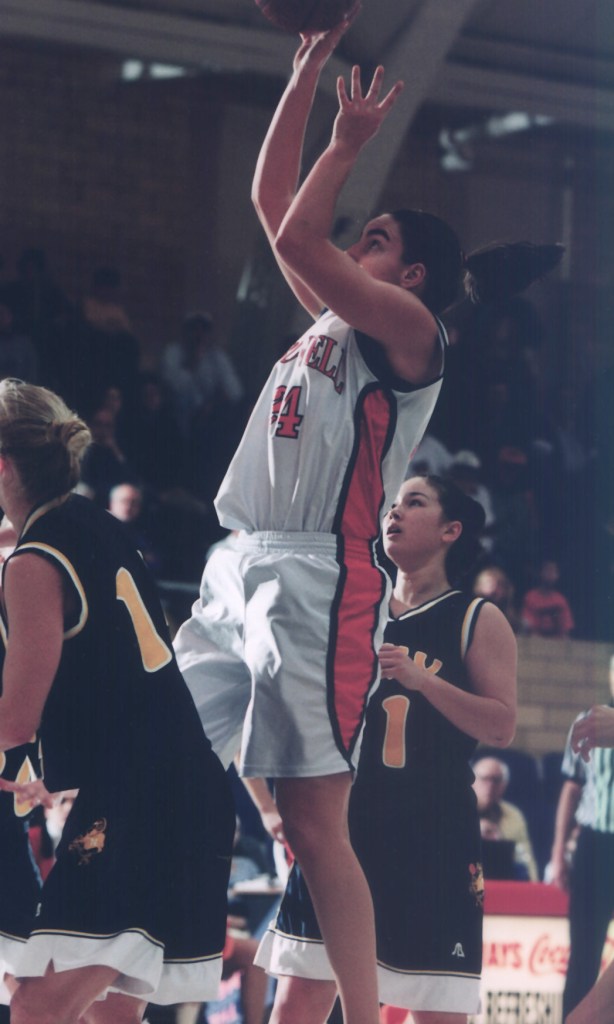 Bucknell forward Monique LeBlanc shoots a right-handed jump shot. A few defenders are nearby but not able to contest the shot.