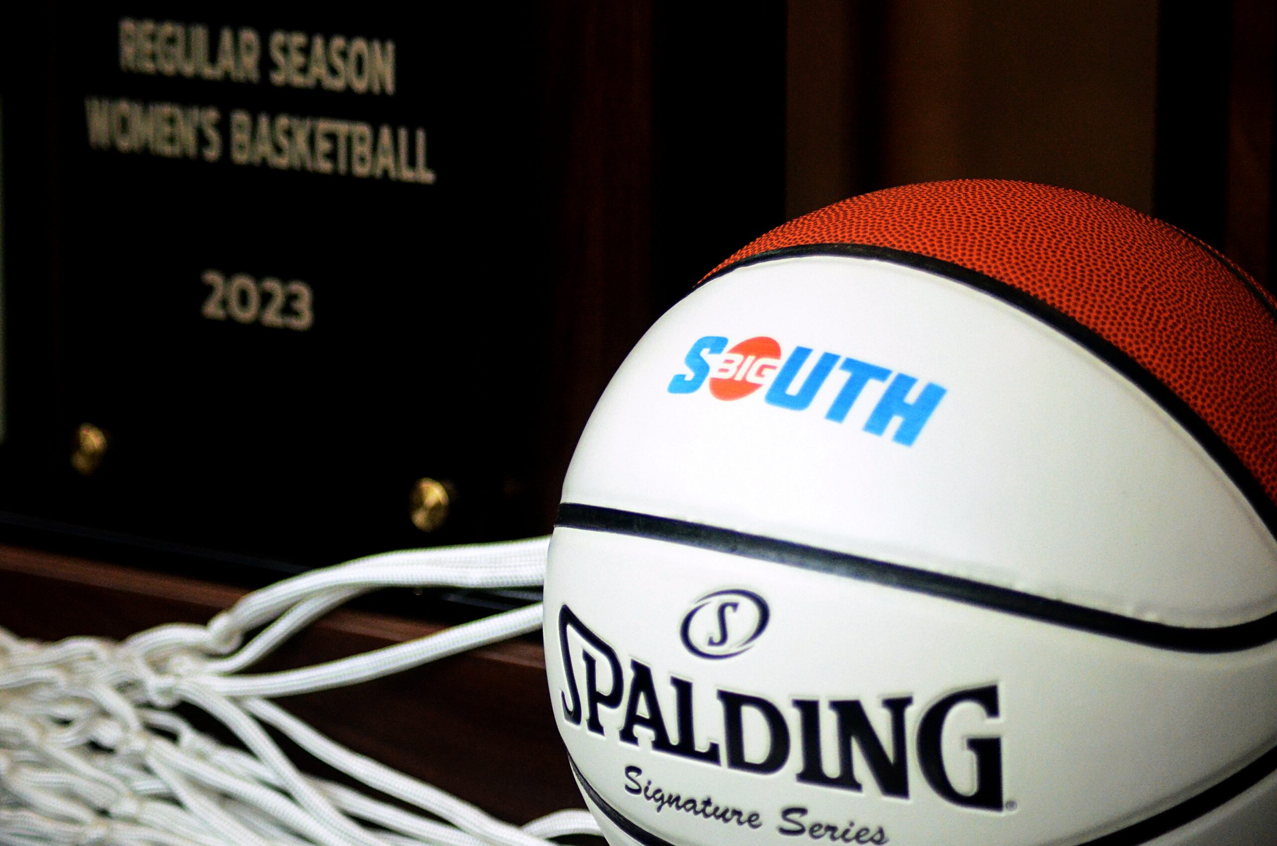A basketball and trophy are displayed at the 2022 Big South basketball media days in Charlotte, N.C. (Mitchell Northam / The Next)