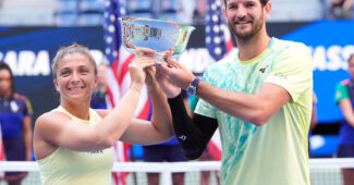 Sara Errani and Andrea Vavassori hold the 2024 U.S. Open mixed doubles trophy