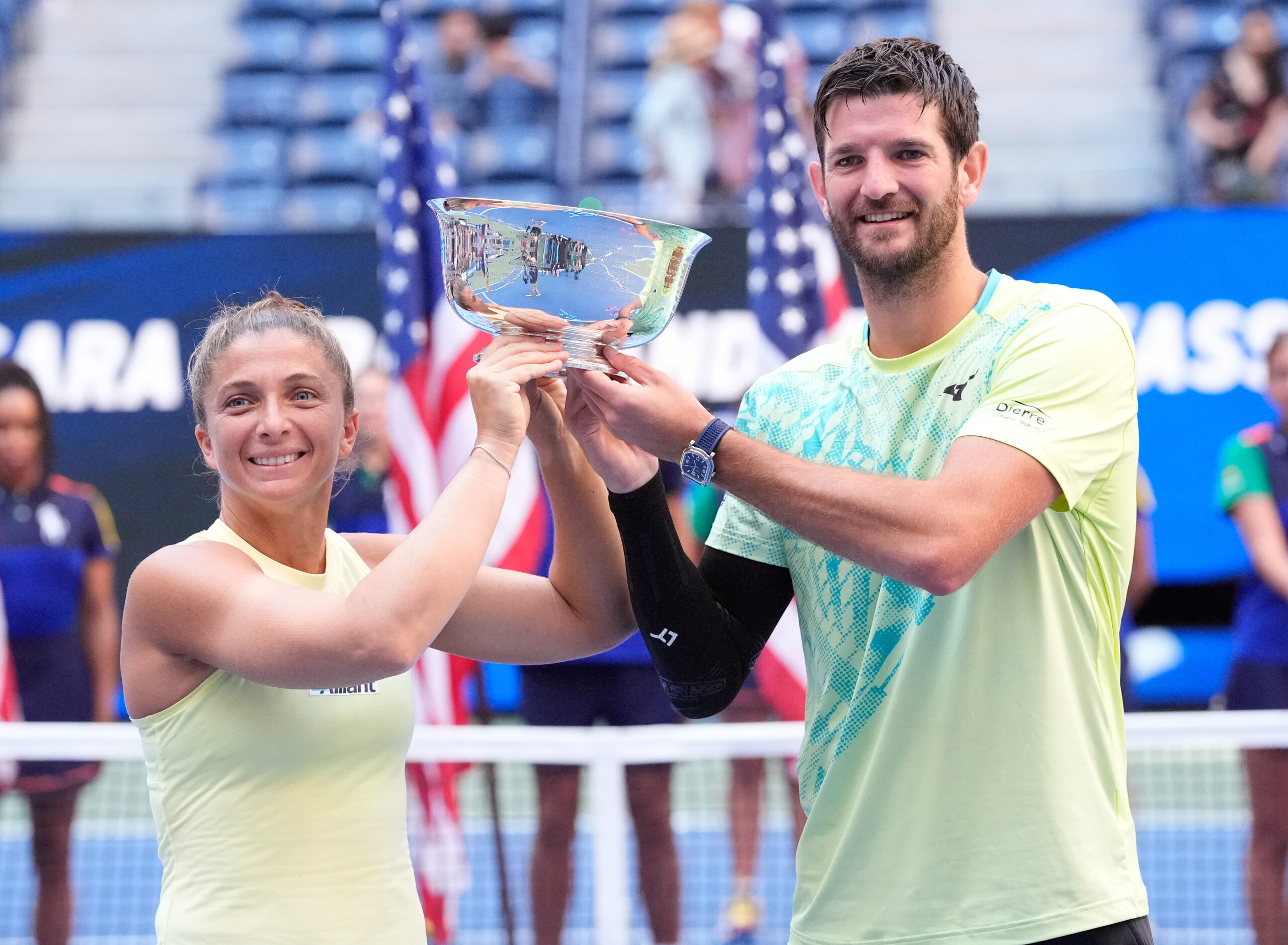 Sara Errani and Andrea Vavassori hold the 2024 U.S. Open mixed doubles trophy