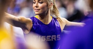 Olivia Dunne, in a purple leotard, warms up before a meet.