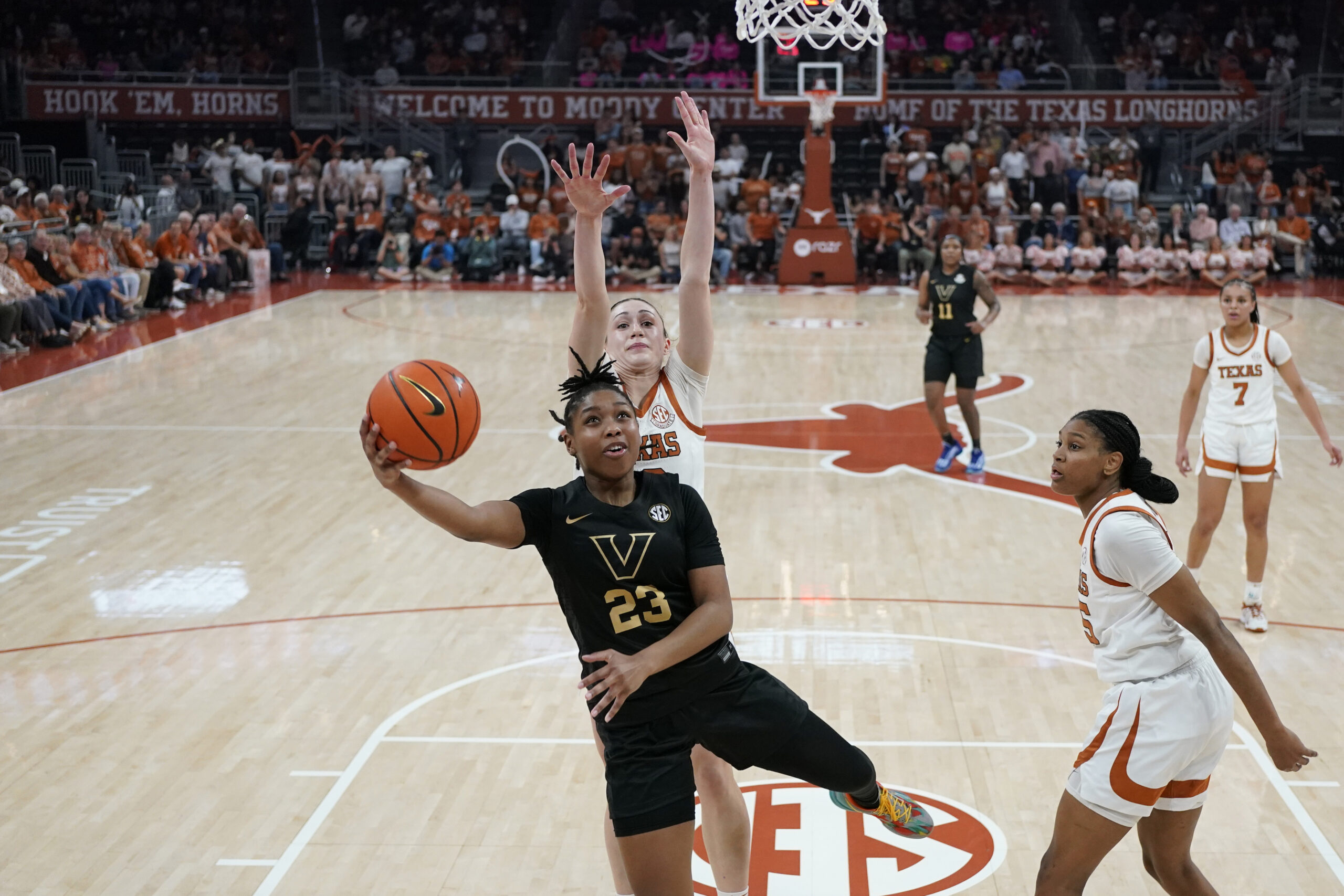 Vanderbilt guard Iyana Moore gets a Texas defender on her back and extends her right arm to attempt a layup.
