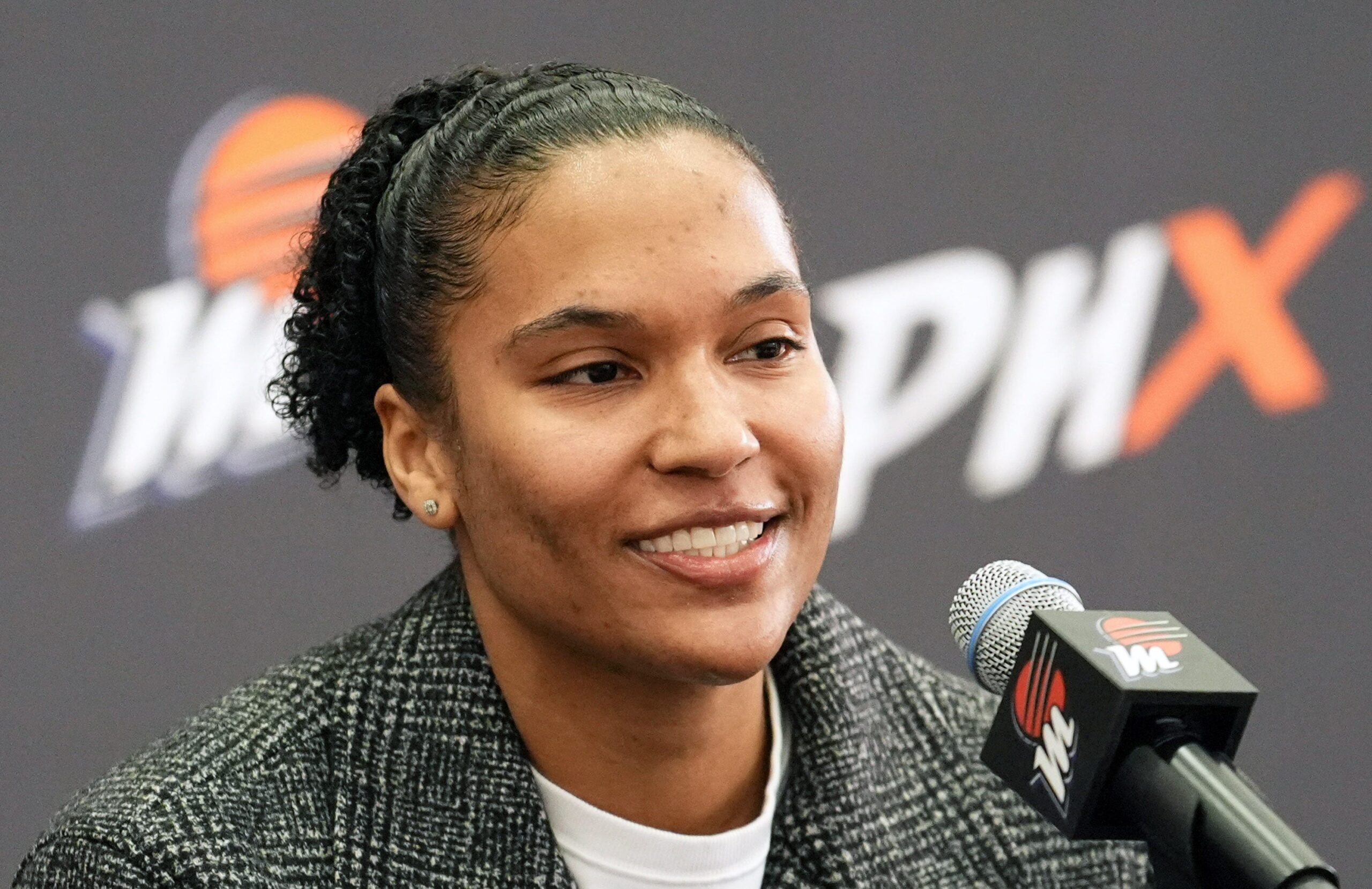 Photo of new Phoenix Mercury forward Alyssa Thomas sitting in front of a microphone addressing the media.