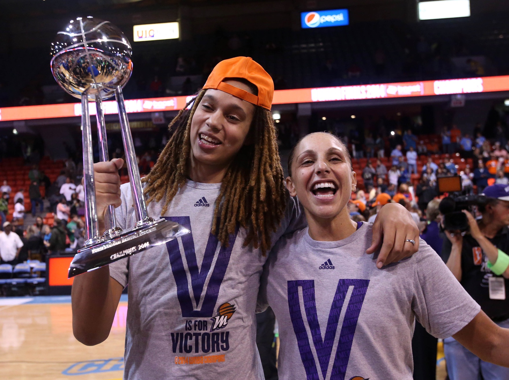 Diana Taurasi, Brittney Griner and a trophy.