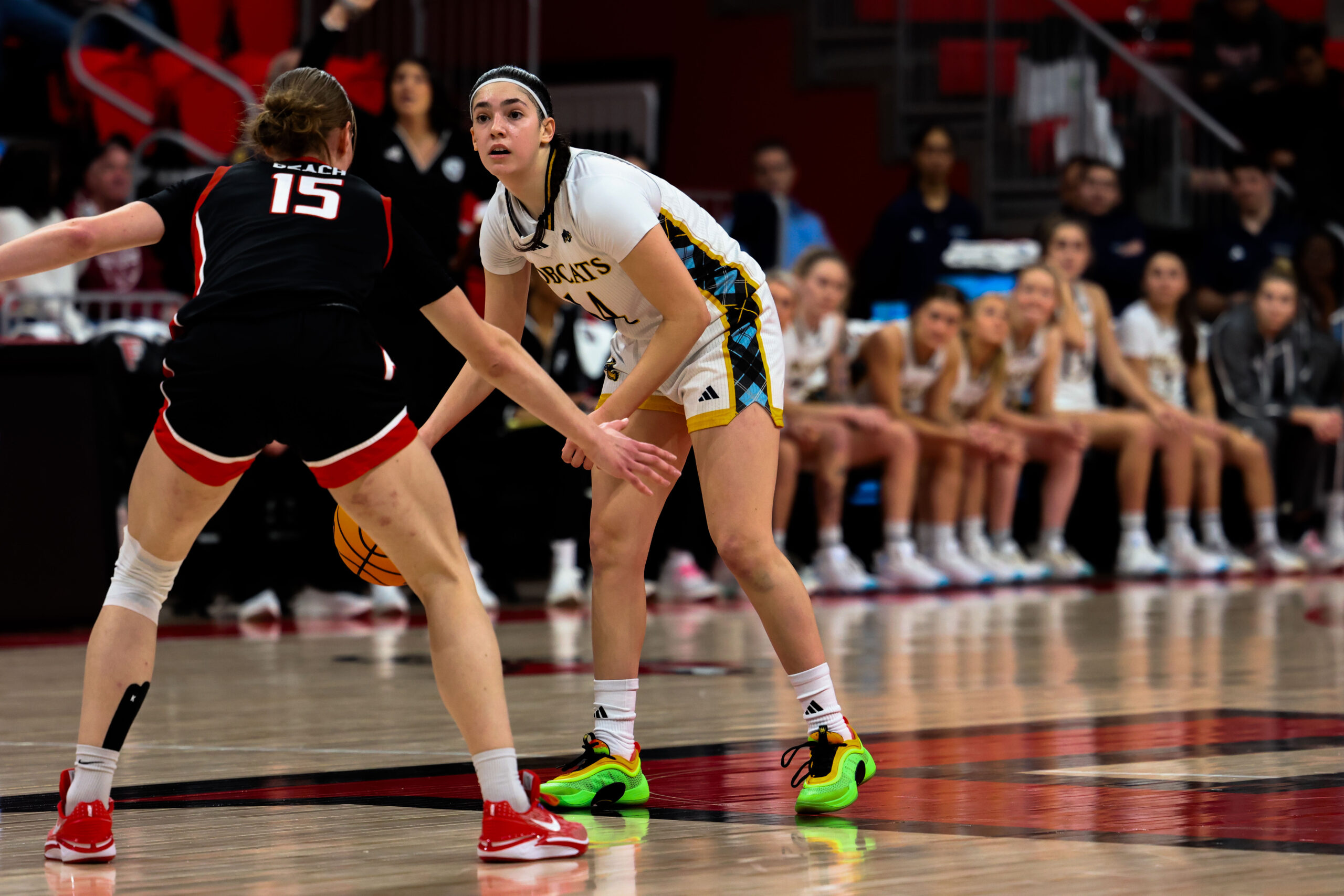 Quinnipiac freshman guard Gal Raviv surveys the court while standing and dribbling the ball with her right hand. (Photo credit: Izzy DiBari).