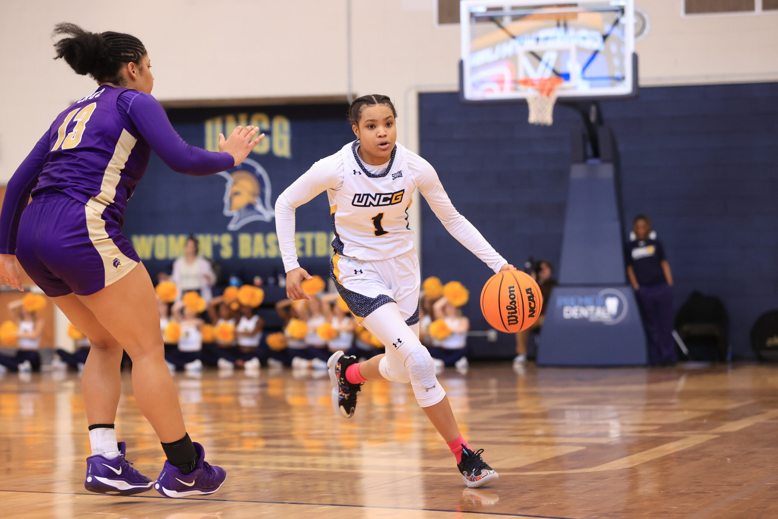 UNCG senior guard Jayde Gamble drives past a defender in a game against Western Carolina on Feb. 22. (Photo credit: Carlos Morales, UNCG Athletics)