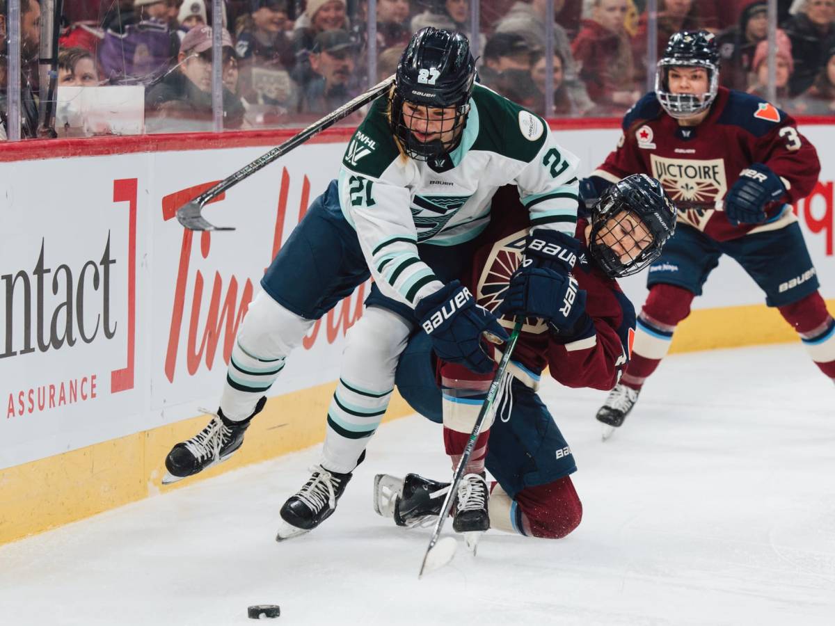 A Montréal player (right in maroon) falls with her stick wrapped around Maloney (left in white), who is leaning into her.