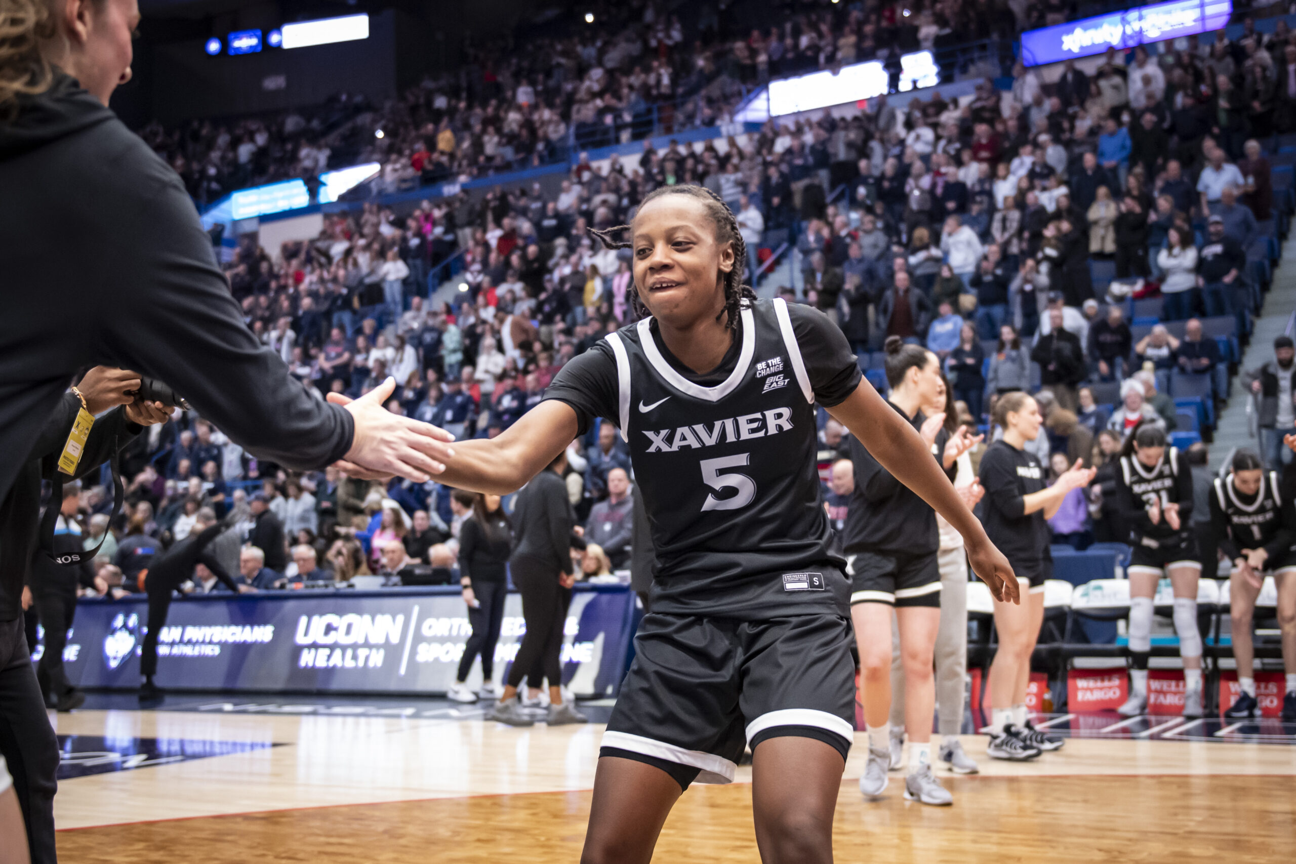 Xavier guard Tae'lor Purvis gives a high-five before a BIG EAST game.