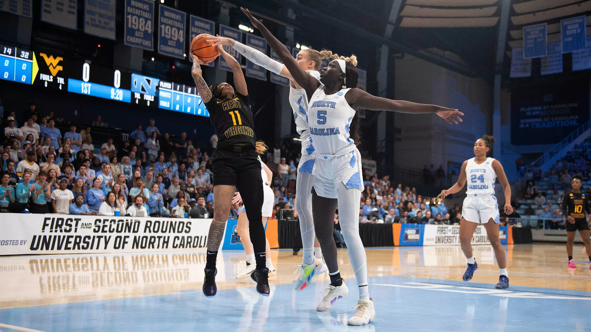 Gakdeng and Ustby jump and extend their arms over JJ Quinerly's shot attempt. Ustby nearly has her fingertips on the ball as it leaves Quinerly's hands.