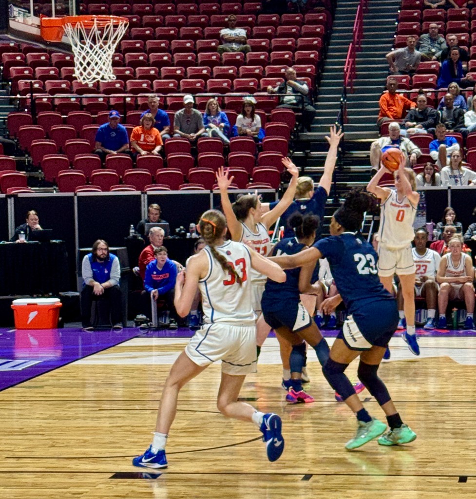 A Boise State basketball player shoots a jump shot against the Nevada Wolfpack.