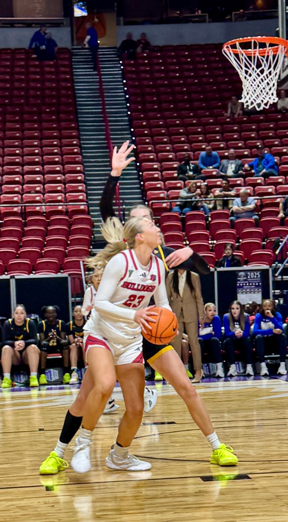 A Fresno State basketball player prepares to shoot over a defender at the Mountain West Conference tournament.