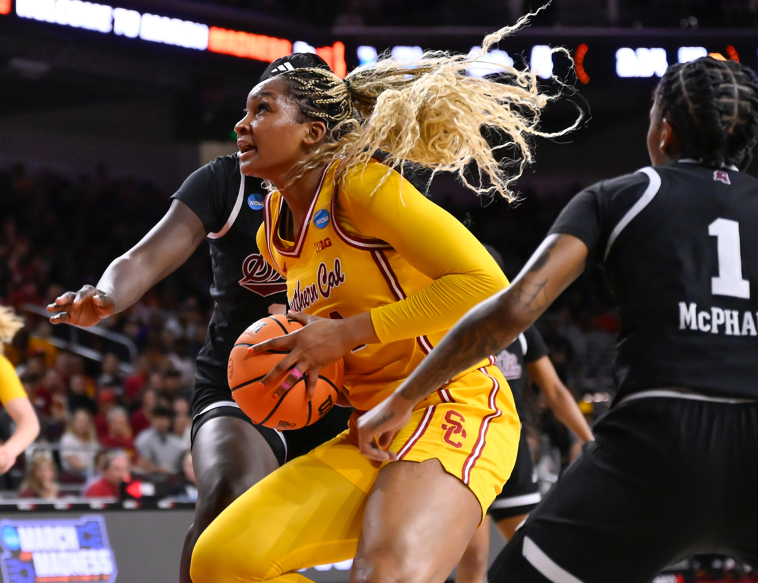 Kiki Iriafen drives toward the basket with the ball in her hands.