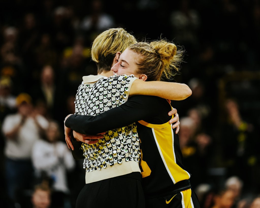 Lucy Olsen hugs Iowa head coach Jan Jensen.