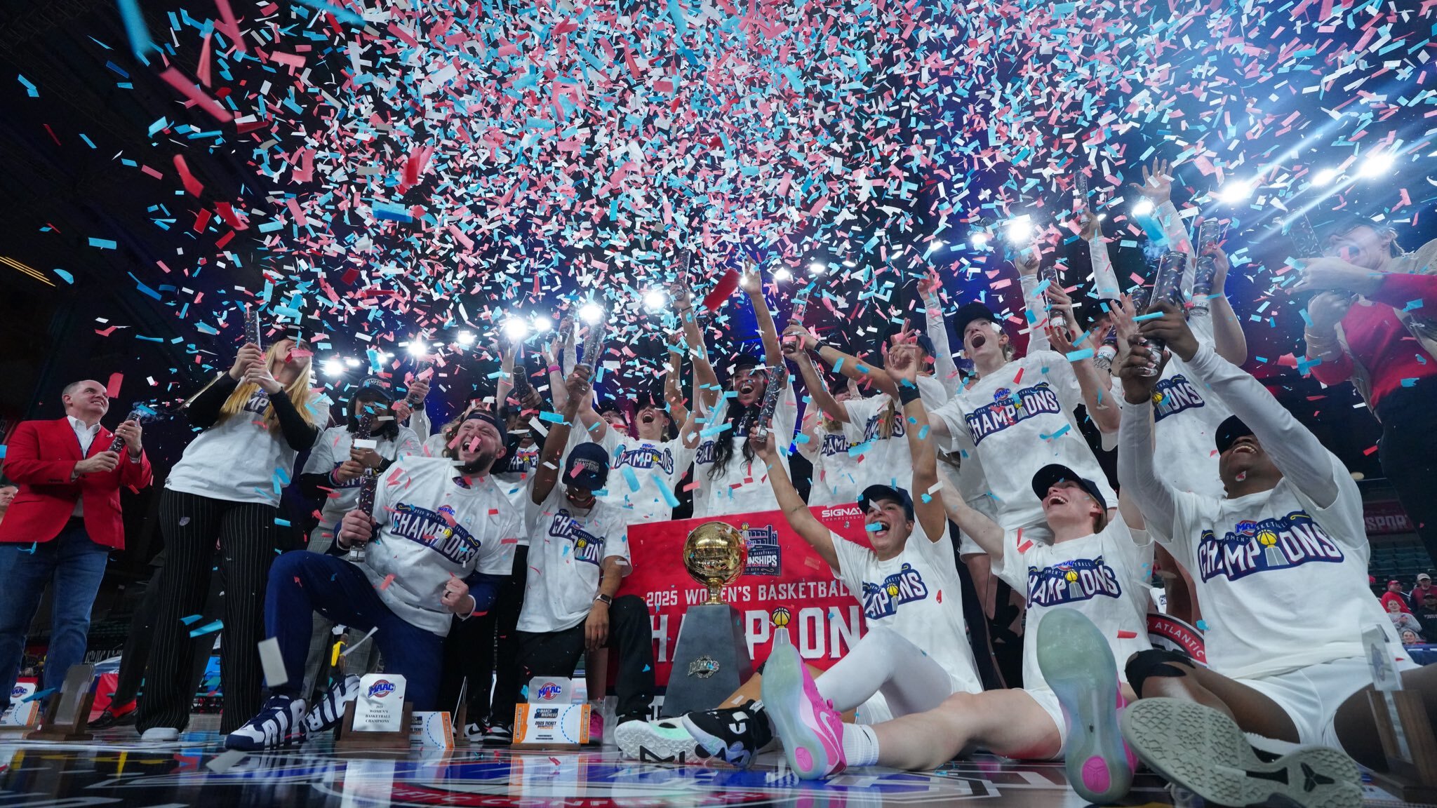 Confetti rains down onto the Fairfield Stags while, all in white, celebrate their 2025 MAAC Tournament title