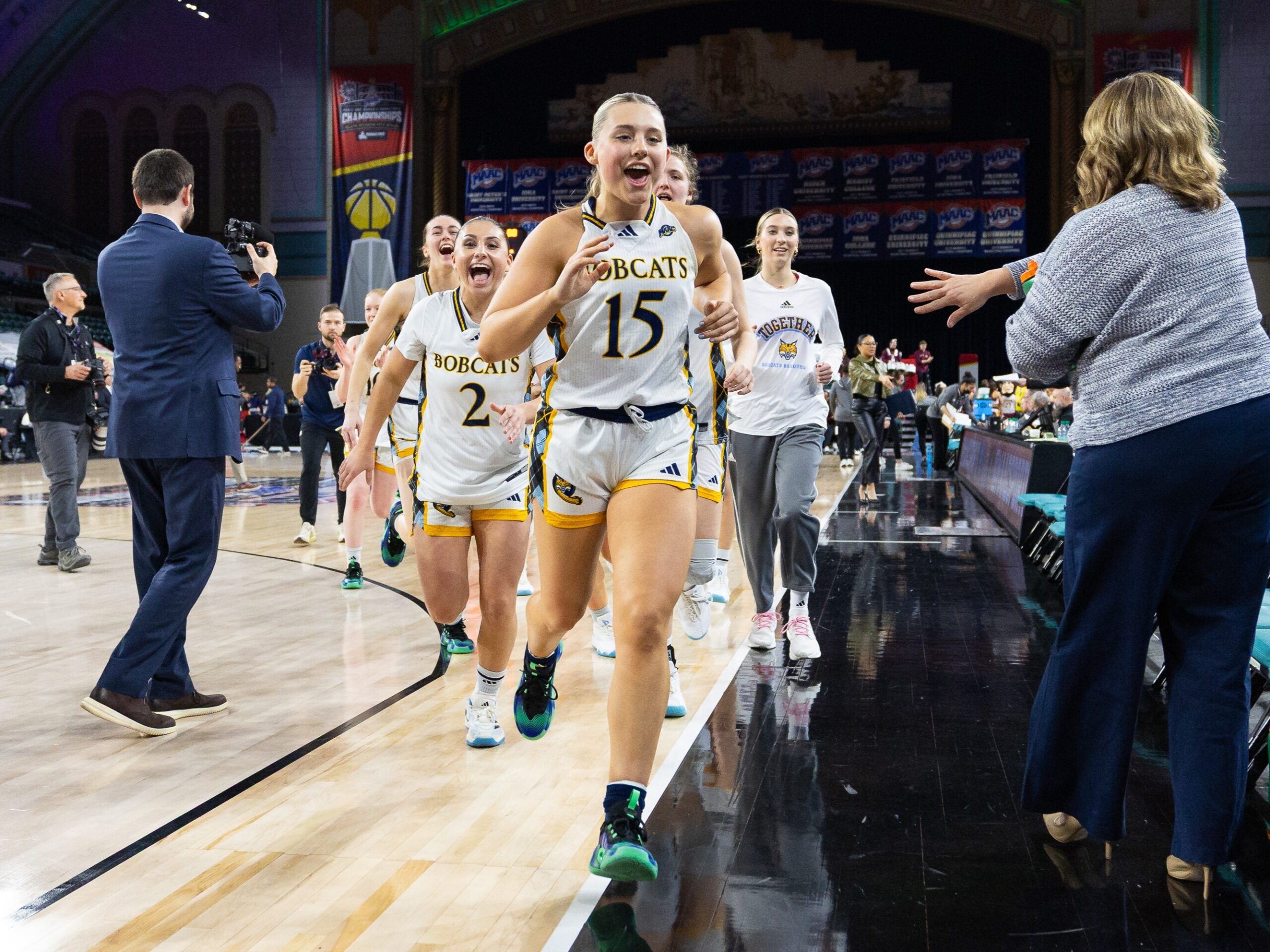 Quinnipiac sophomore guard Karson Martin runs off the court with the team behind her after Quinnipiac's 79-51 win over Iona Wednesday afternoon in the MAAC Tournament. (Photo credit: Rob Rasmussen | P8 Photos).