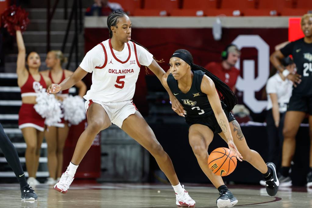 UCF Knights guard Kaitlin Peterson (3) moves around Oklahoma Sooners forward Kiersten Johnson (5)